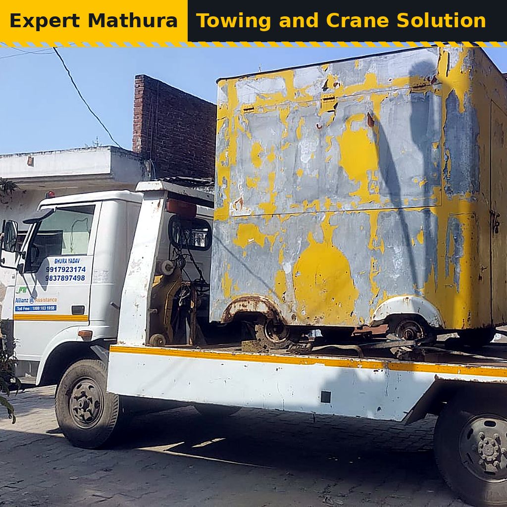 Platform truck carrying a large yellow cabin, heavy load and vehicle shifting from Mathura